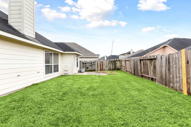 view of yard with a fenced backyard