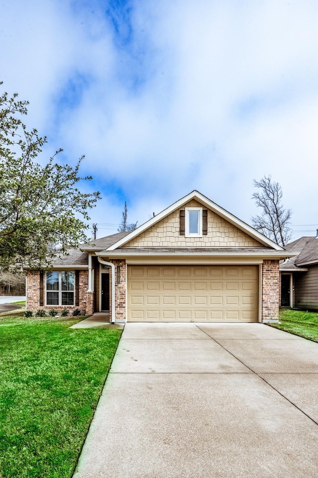 view of front of home with a garage, brick siding, driveway, and a front lawn