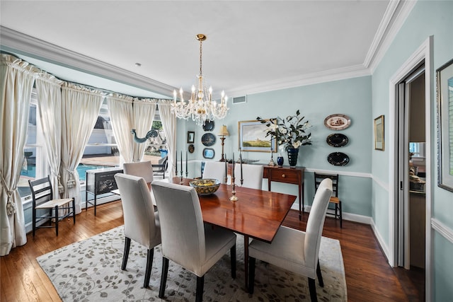 dining room with baseboards, visible vents, dark wood-type flooring, crown molding, and a notable chandelier