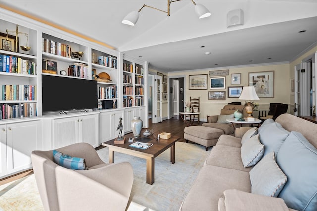 living area featuring vaulted ceiling, ornamental molding, and light wood-style flooring