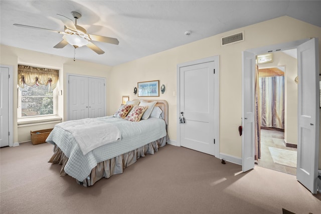 bedroom with baseboards, a ceiling fan, visible vents, and light colored carpet