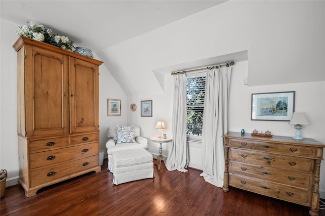 sitting room with lofted ceiling and dark wood-type flooring