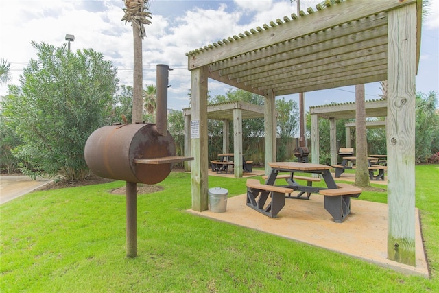 view of home's community with a patio area, a yard, fence, and a pergola