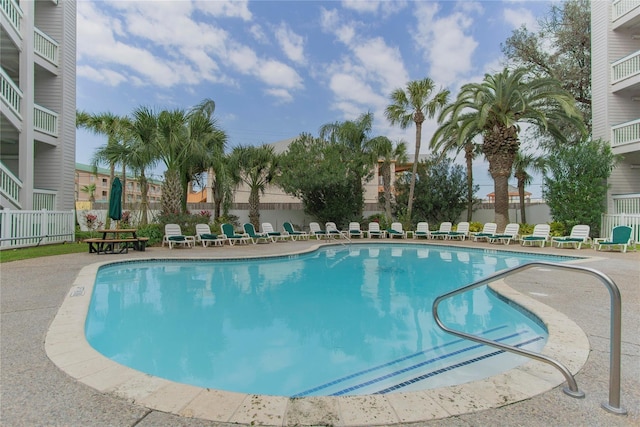 community pool featuring a patio area and fence