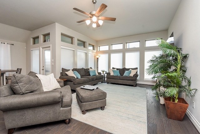 living room featuring a ceiling fan, a wealth of natural light, vaulted ceiling, and wood finished floors