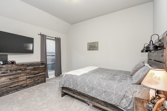 bedroom with carpet floors and vaulted ceiling