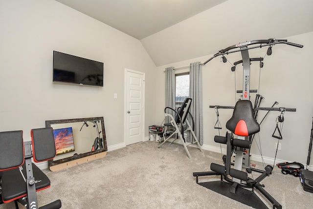 workout room featuring carpet flooring, vaulted ceiling, and baseboards