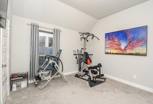 workout area featuring vaulted ceiling, carpet, and baseboards