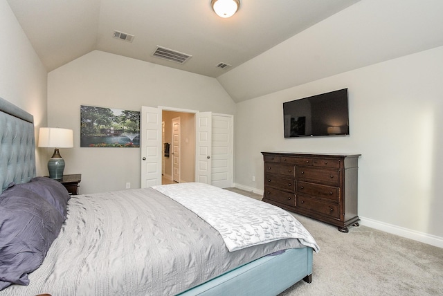 bedroom featuring light carpet, visible vents, and vaulted ceiling