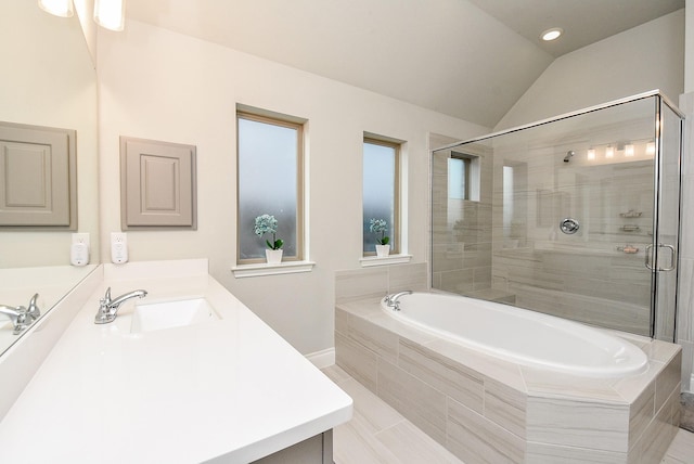 bathroom with a stall shower, vaulted ceiling, a bath, and vanity