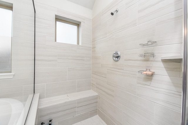 full bath featuring a tile shower