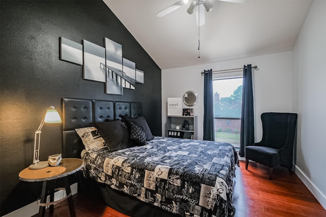 bedroom featuring dark wood-style floors, vaulted ceiling, baseboards, and ceiling fan