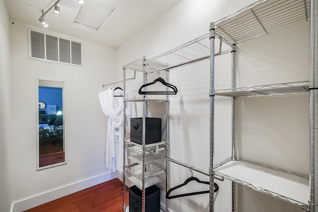 interior space featuring attic access, visible vents, and wood finished floors