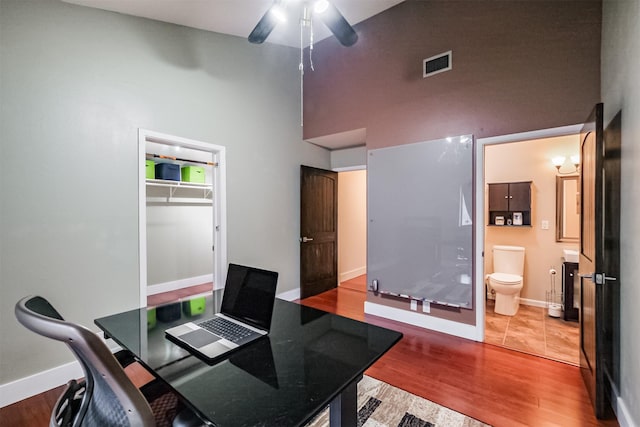 office with visible vents, baseboards, and wood finished floors