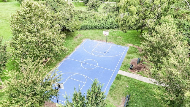 view of basketball court with a yard and basketball hoop