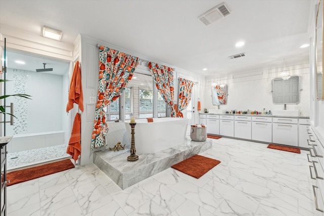 full bathroom featuring marble finish floor, visible vents, a freestanding bath, and a walk in shower