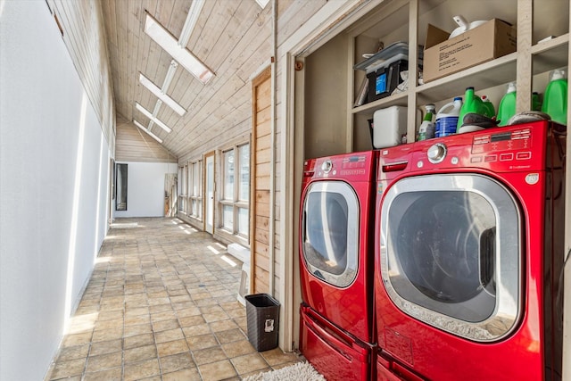 washroom featuring laundry area, washer and clothes dryer, and a skylight