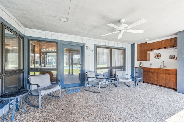 interior space with wood walls and ceiling fan