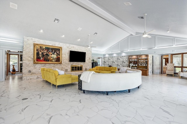 living area featuring a ceiling fan, marble finish floor, visible vents, and a fireplace