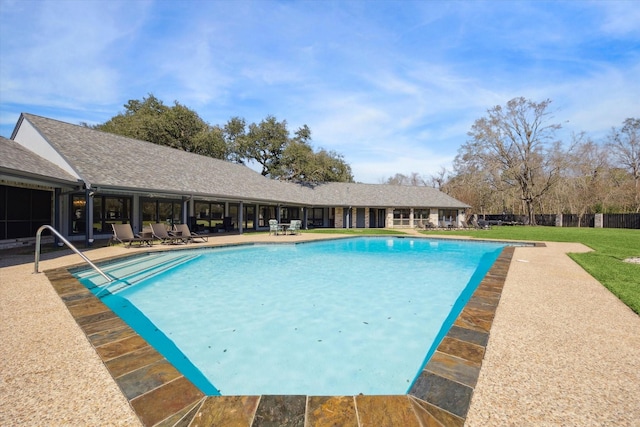 view of swimming pool with a fenced in pool and a lawn