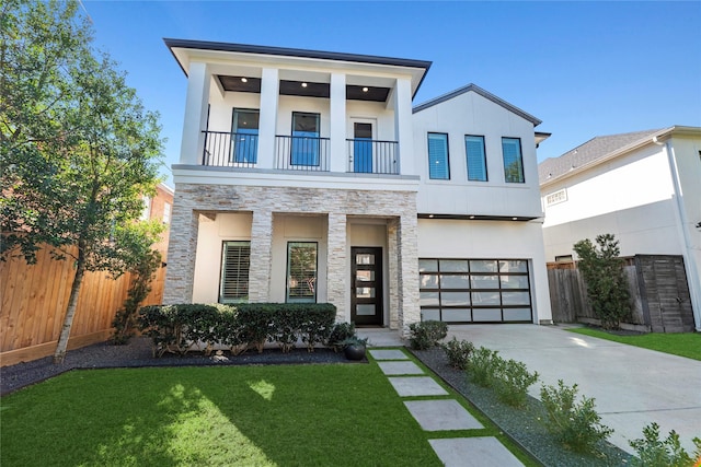 view of front of house with an attached garage, a balcony, stone siding, driveway, and stucco siding