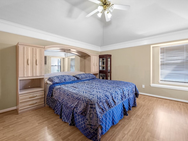 bedroom with lofted ceiling, baseboards, and wood finished floors