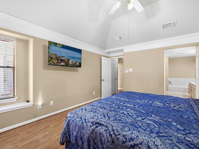 bedroom with lofted ceiling, light wood-style flooring, visible vents, and baseboards