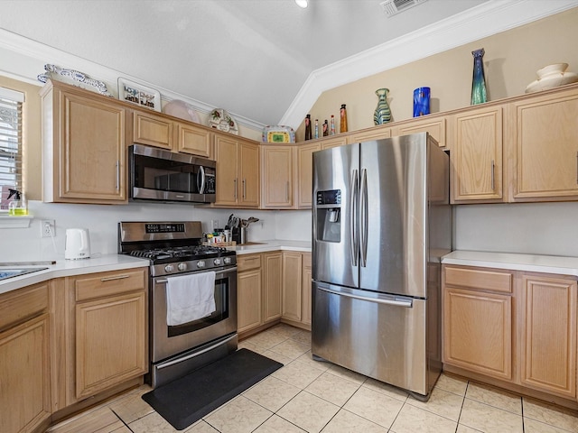 kitchen featuring vaulted ceiling, crown molding, stainless steel appliances, light countertops, and light tile patterned flooring