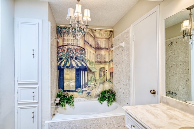 full bathroom with a chandelier, a garden tub, a textured ceiling, and vanity