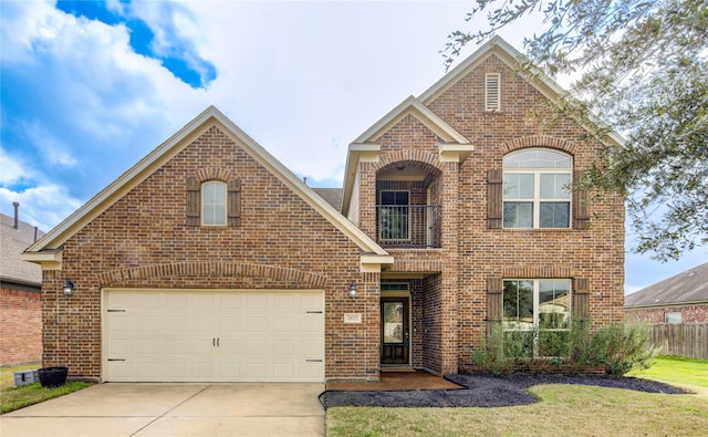 traditional home featuring fence, a front lawn, concrete driveway, and brick siding