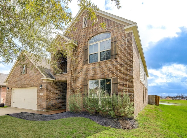 traditional-style home featuring concrete driveway, brick siding, and a front yard