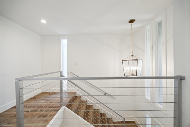 room details with baseboards, recessed lighting, wood finished floors, and a notable chandelier