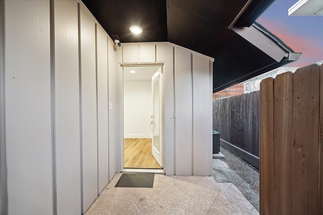 entrance to property with board and batten siding and fence