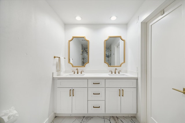 bathroom featuring double vanity, marble finish floor, a sink, and recessed lighting