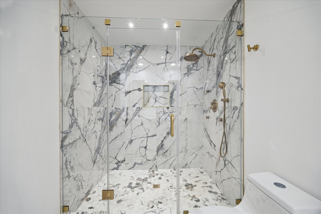 full bathroom with toilet and a marble finish shower