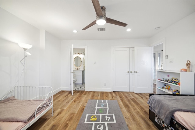 bedroom with visible vents, baseboards, connected bathroom, light wood-style flooring, and recessed lighting