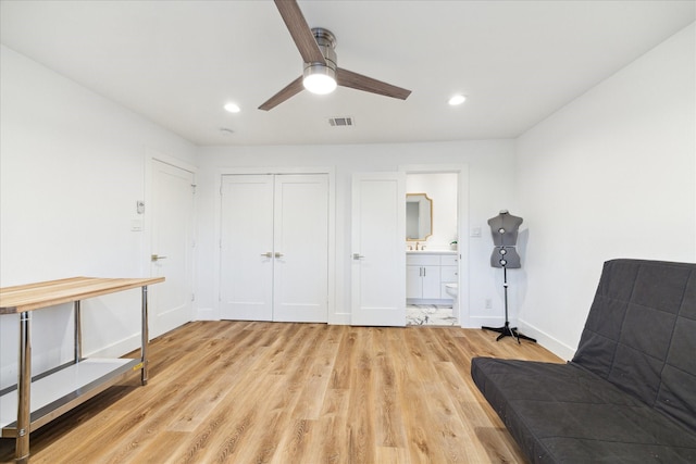 living area with light wood-style flooring, visible vents, baseboards, and recessed lighting