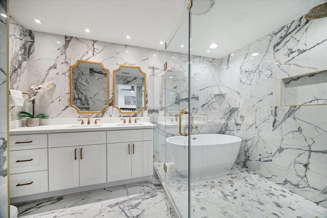 bathroom with double vanity, recessed lighting, a soaking tub, a sink, and stone wall