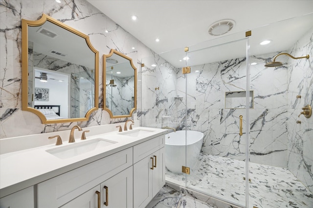 full bathroom featuring marble finish floor, a sink, a marble finish shower, and stone wall