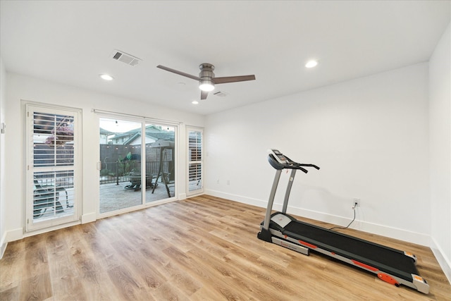 exercise area featuring visible vents, ceiling fan, light wood-style flooring, and baseboards