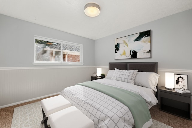 carpeted bedroom featuring baseboards