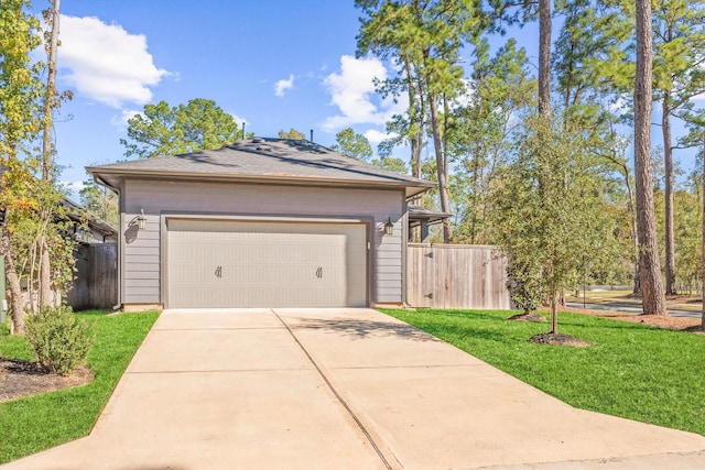 exterior space featuring concrete driveway, a front yard, and fence