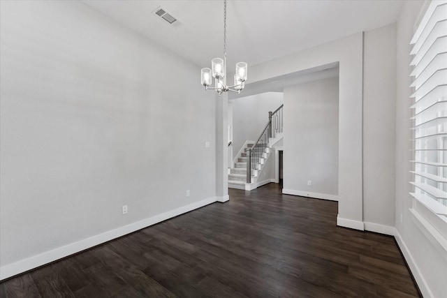 unfurnished dining area featuring dark wood-style floors, stairway, visible vents, and baseboards