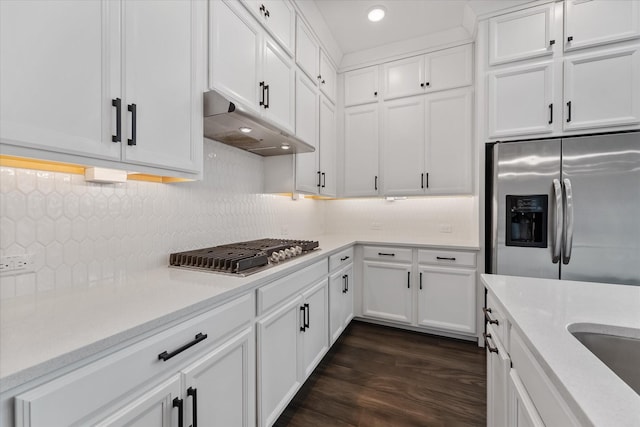 kitchen featuring dark wood finished floors, appliances with stainless steel finishes, light countertops, under cabinet range hood, and white cabinetry