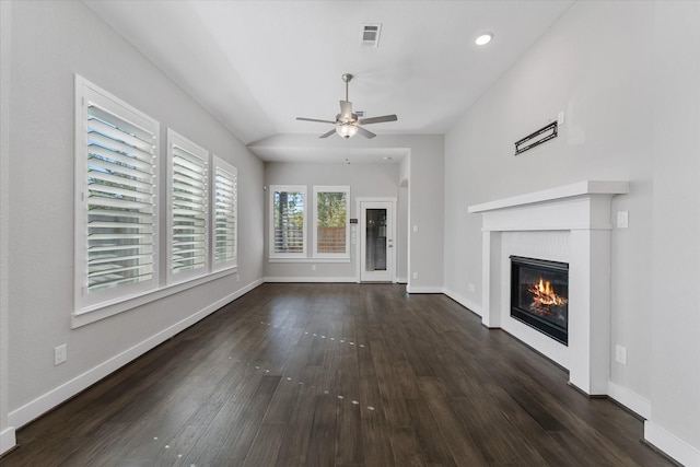 unfurnished living room featuring dark wood finished floors, visible vents, and baseboards