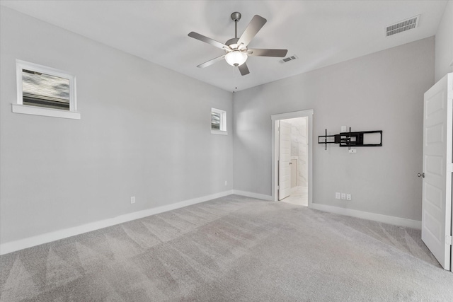 unfurnished room featuring visible vents, ceiling fan, light carpet, and baseboards