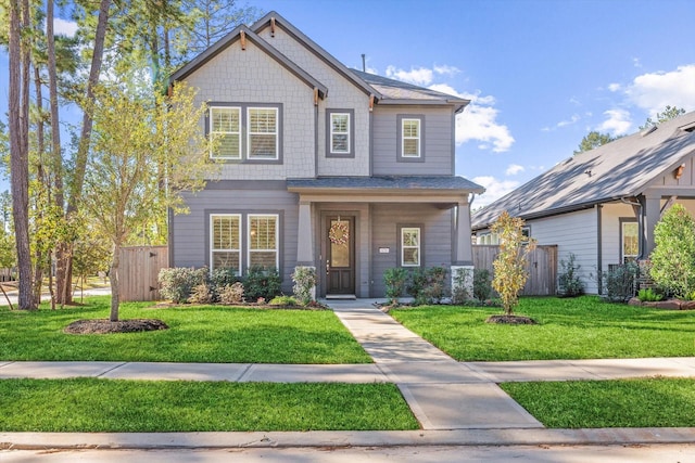 craftsman inspired home with fence and a front yard