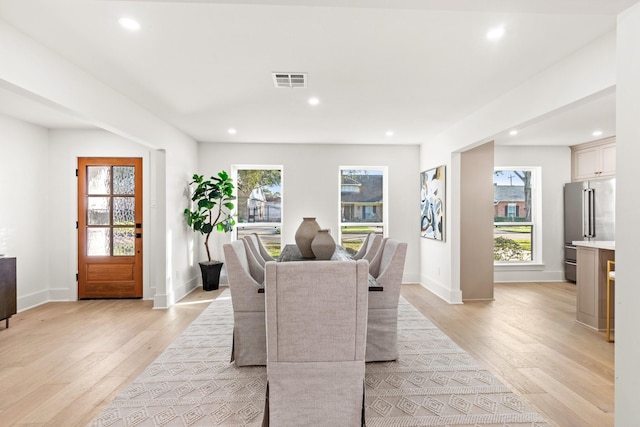 dining space featuring light wood-type flooring, a healthy amount of sunlight, visible vents, and recessed lighting