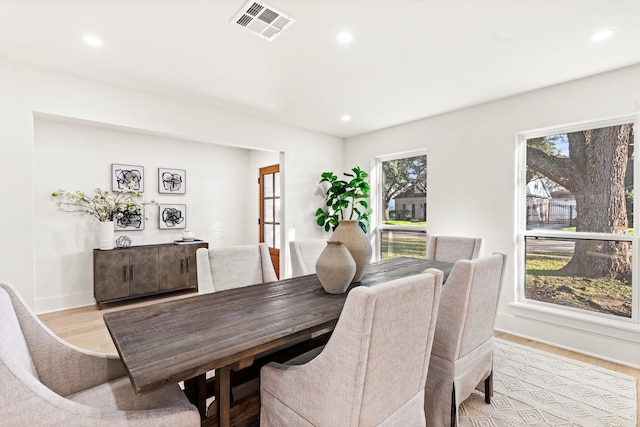 dining space featuring light wood finished floors, baseboards, visible vents, and recessed lighting