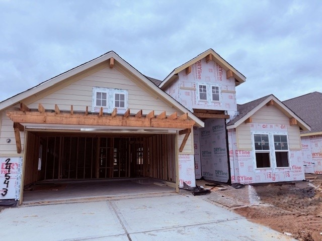 property under construction featuring driveway and an attached garage